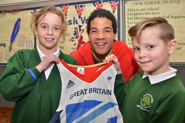 Paralympian athlete Sam Ruddock shows young ambassadors Katie Marsh and Kyle Roberts his London 2012 competition vest at Linchfield Community Primary School, Deeping St James. Photo by Tim Wilson.