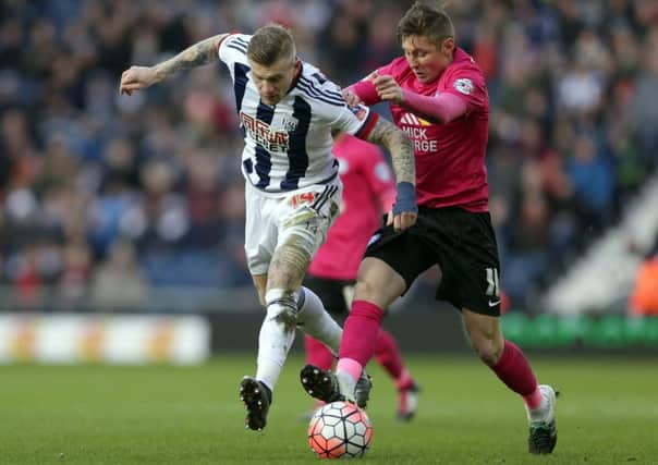 Harry Beautyman of Posh challenges West Brom's James McClean for possession during the FA Cup fourth round tie at the Hawthorns. Photo: Joe Dent/theposh.com.