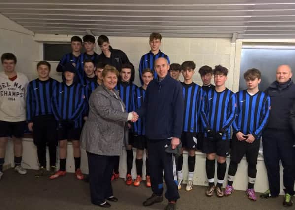 Local McDonald's business manager Cheryl Carter with Ryhall Under 16s.