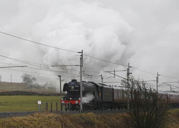 The Flying Scotsman leaves Tebay in Cumbria as it hauls the Winter Cumbrian Mountain Express on a route traveling through the Lune Gorge to Tebay, continuing to a village called Shap. PRESS ASSOCIATION Photo. Picture date: Saturday February 6, 2016. After crossing the Cumbrian Fells it will descend to Penrith, and then head for Carlisle. It will pass over high viaducts, including Ribblehead, then through Settle, Hellifield, Clitheroe and Blackburn. See PA story RAIL Scotsman. Photo credit should read: Peter Byrne/PA Wire RAIL_Scotsman_133135.JPG
