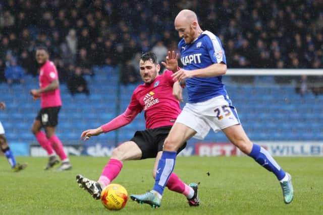 Posh full-back Michael Smith is about to collect his first yellow card at Chesterfield for a foul on Drew Talbot> Photo: Joe Dent/theposh.com.
