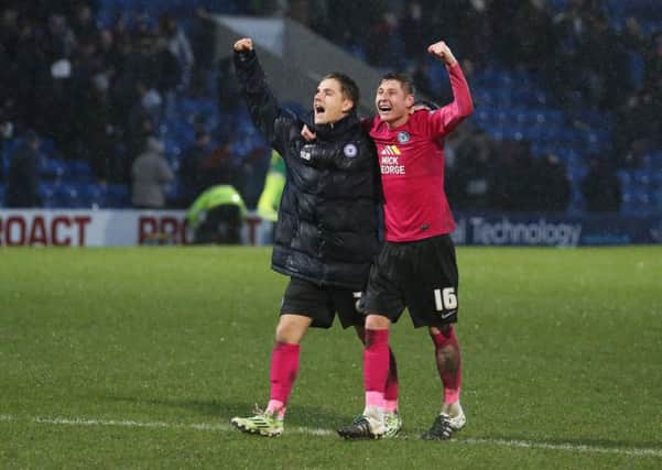 Match-winner Tom Nichols (left) and substitute Harry Beautyman celebrate the Posh win in front of the visiting fans at Chesterfield. Photo: Joe Dent/theposh.com.