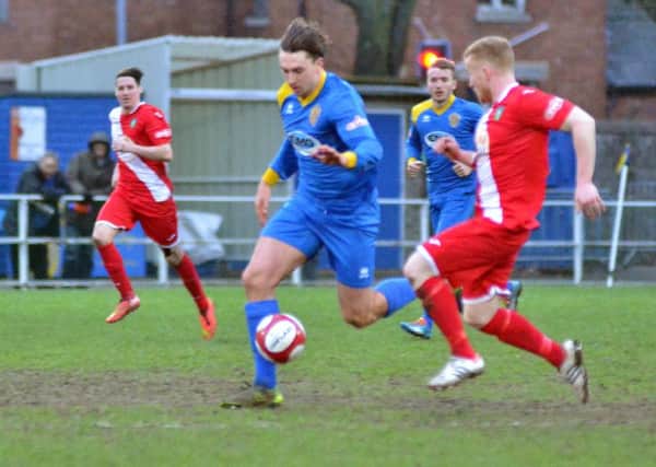 Action from Spalding United's (blue) win over Kidsgrove Athletic. Photo: Tim Wilson.