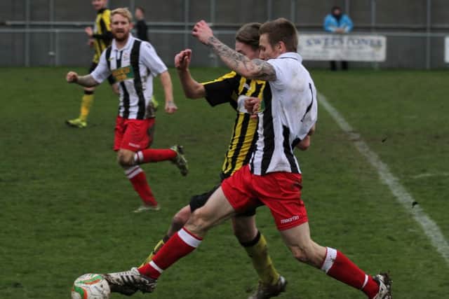 Action from Holbeach 4, Peterborough Northern Star 2. Andy Buckle (white) is the Star player. Photo: Tim Gates.