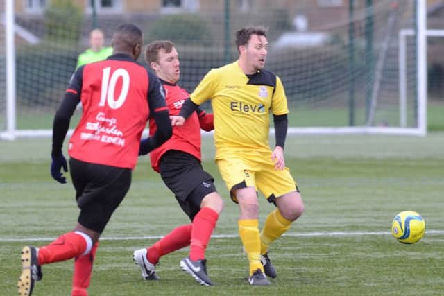 Ash Jackson (red) in action for Netherton United against Raunds. Photo: David Lowndes.