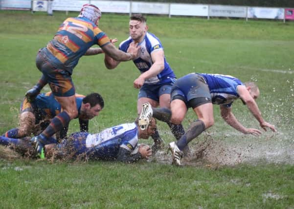 Lions try to make headway on a waterlogged Old Halesonians pitch. Picture: Mick Sutterby