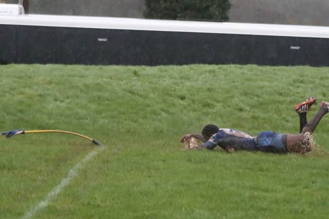 Vernon Horne scores the Lions try . . . with the corner flag flattened by the wind. Picture: Mick Sutterby