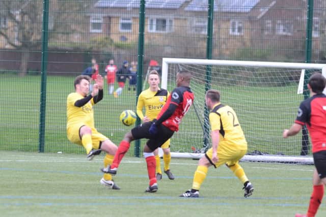 Action from the Northants Junior Cup semi-final between Netherton (red) and Raunds at the Grange. Photo: David Lowndes.