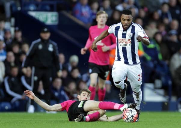 Posh defender Jack Baldwin attempts to tackle West Brom's Stephane Sessegon at the Hawthorns.