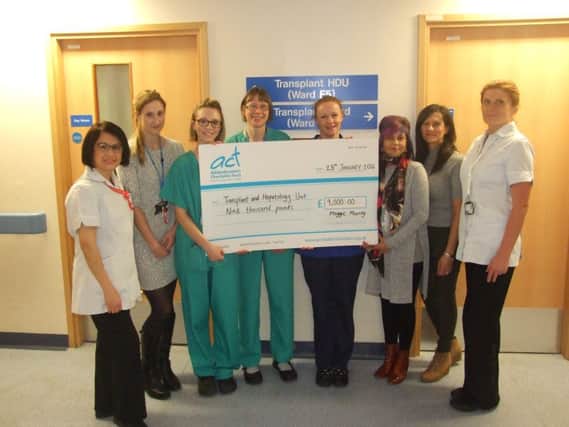 Maggie (third right) with her sister Emma Malcolm (2nd right) and staff from the transplant ward with the latest cheque for Â£9,000.
