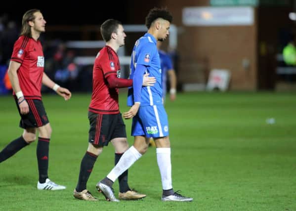 Lee Angol of Posh consoled by West Brom midfielder Craig Gardner after seeing the final penalty in the shoot-out saved. Photo: Joe Dent/theposh.com.
