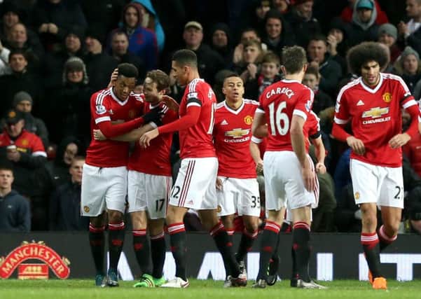 Manchester United players celebrate a goal.