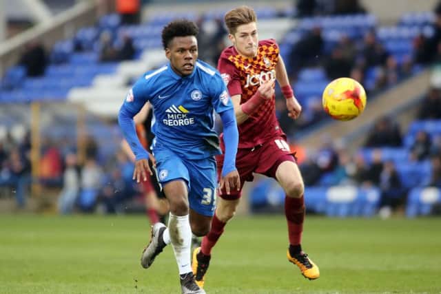 Shaquile Coulthirst of Peterborough United gets away from Bradford City's Reece Burke. Picture: Joe Dent