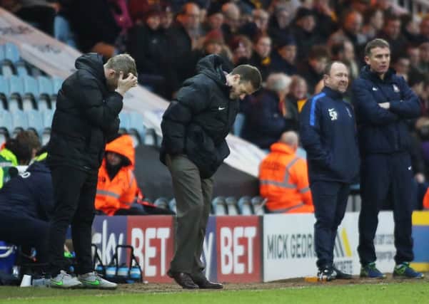 Peterborough United manager Graham Westley and assistant manager Grant McCann cut dejected figures. Picture: Joe Dent