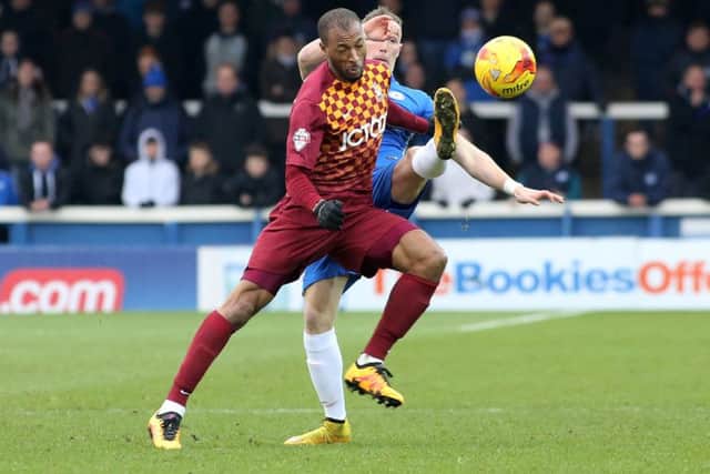 Posh substitute Marcus Maddison battles for possession with Bradford City striker West Thomas.