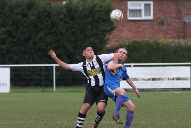 Christian Le (stripes) in action for Peterborough Northern Star against Cogenhoes. Photo: Tim Gates.