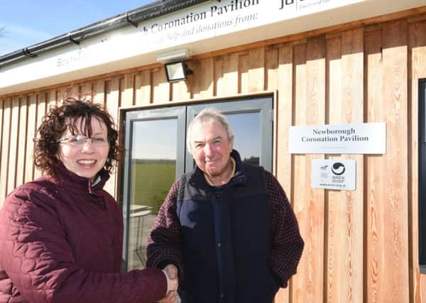 Sarah Gosling from WREN with  Newborough Playing Field Committee chairman Nick Harris in front of the new pavilion.