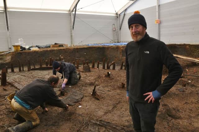 Bronze Age wheel found at Must Farm archaeological dig at Kings Dyke. Pictured is expert Mark Knight EMN-160218-133112009