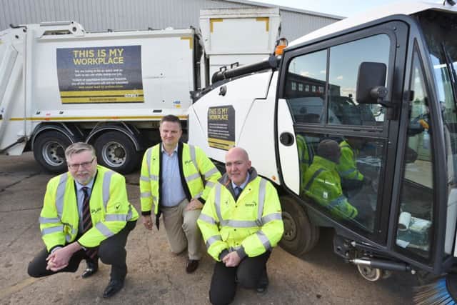 Martin Raper (Amey account director), Cllr Gavin Elsey and Mick Robb (head of waste and recycling) with their new signs on some council vehicles EMN-160219-173951009