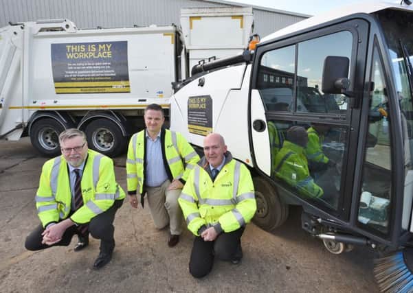 Martin Raper (Amey account director), Cllr Gavin Elsey and Mick Robb (head of waste and recycling) with their new signs on some council vehicles EMN-160219-173951009