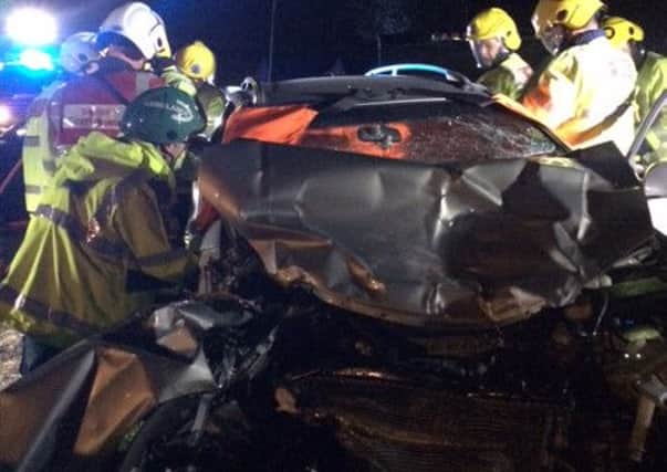 Fire crews cut a woman free from this car following the crash