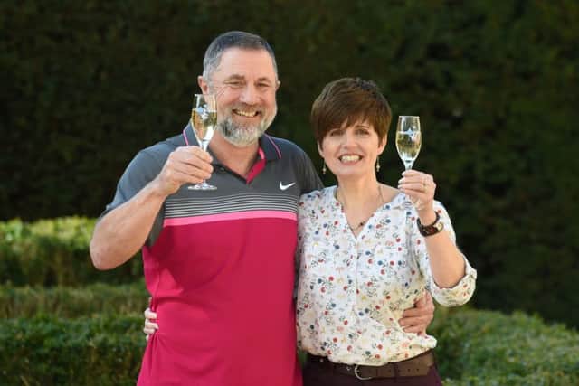 Gerry Cannings, 63, and his wife Lisa, 48, from near Peterborough, Cambridgeshire, celebrate at the city's Orton Hall Hotel after winning a £32.5 million rollover Lotto jackpot. Photo credit: Joe Giddens/PA Wire LOTTERY_Jackpot_125451.JPG