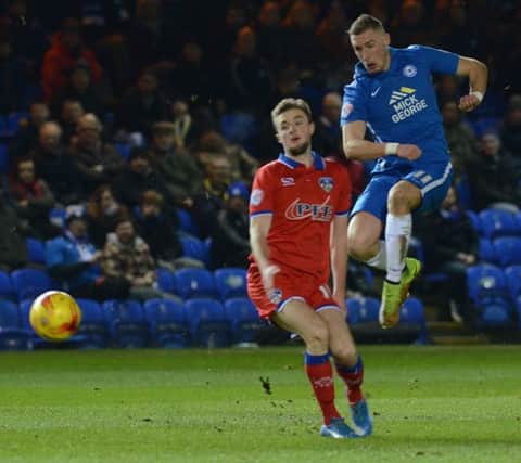 Posh man-of-match Marcus Maddison shoots at goal against Oldham. Photo: David Lowndes.