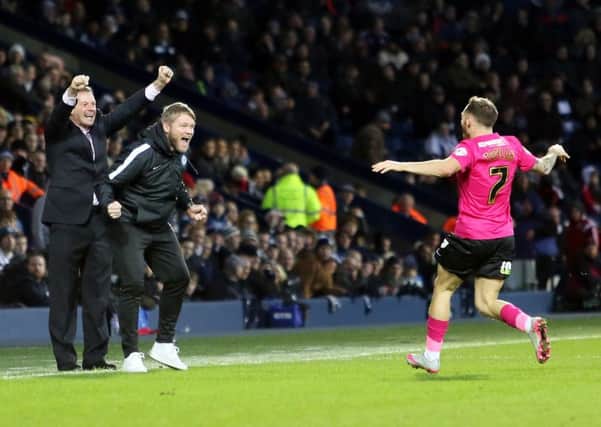 Posh manager Graham Westley (left) celebrates Jon Taylor's goal in the FA Cup draw at West Brom.