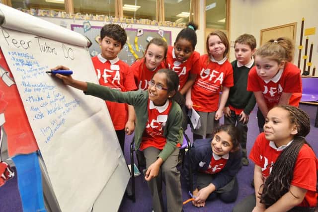 Ananya Aravindhan (10) with pupils from Woodston and Nene Valley primary schools taking part in a UFA programme to help younger pupils EMN-160225-165955009