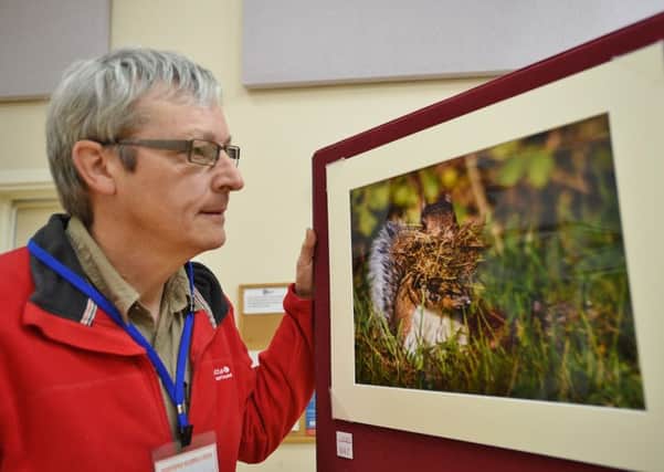 Kevin Maxfield with his photograph of a squirrel at Deepings Camera Club's 13th annual exhibition at Deepings Community Centre. Market Deeping.  Photo by David Lowndes.