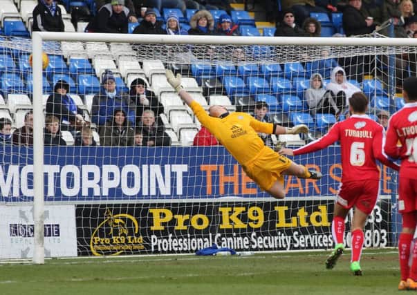 Debutant Posh goalkeeper Stuart Moore can't quite reach a superb free-kick strike from Swindon's Nicky Ajose. Photo: Joe Dent/theposh.com.