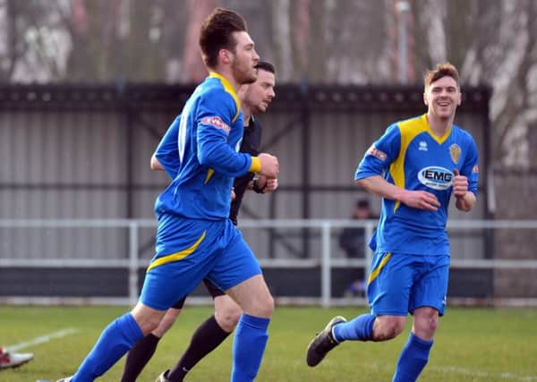 Tom Waumsley trots back to the centre circle after one of his three goals for Spalding United against Goole. :