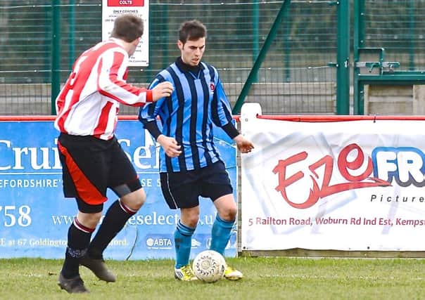 Andrew Tidswell (blue) scored for Holbeach against Huntingdon.