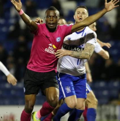Gabriel Zakuani of Peterborough United battles with Bury's Peter Clarke. Picture: Joe Dent