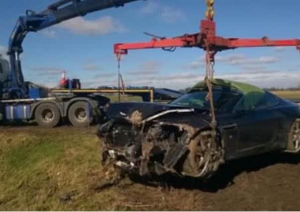 The Aston Martin Vantage is recovered by police