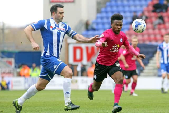 Shaquile Coulthirst of Peterborough United in action with Craig Morgan of Wigan Athletic. Picture: Joe Dent