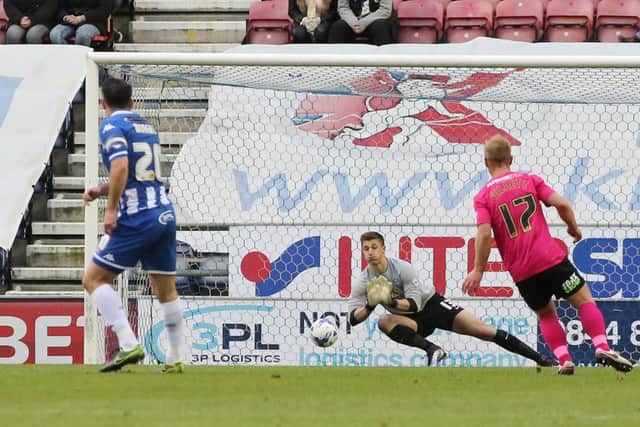 Young Posh goalkeeper Stuart Moore makes a save at Wigan. Photo: Joe Dent/theposh.com.