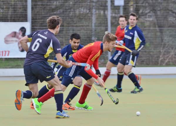 Adam Wilson (red) scored twice for City of Peterborough against Blueharts. Photo: David Lowndes.