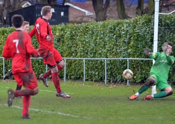 Jack Humphries scores for Bourne in a 6-1 United Counties Division One win over Burton Park Wanderers last weekend. Photo: Tim Wilson.