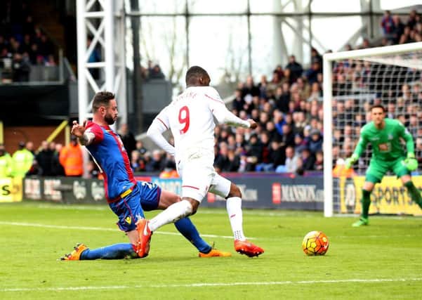 Liverpool's Christian Benteke is 'fouled' by Damien Delaney of Crystal Palace.