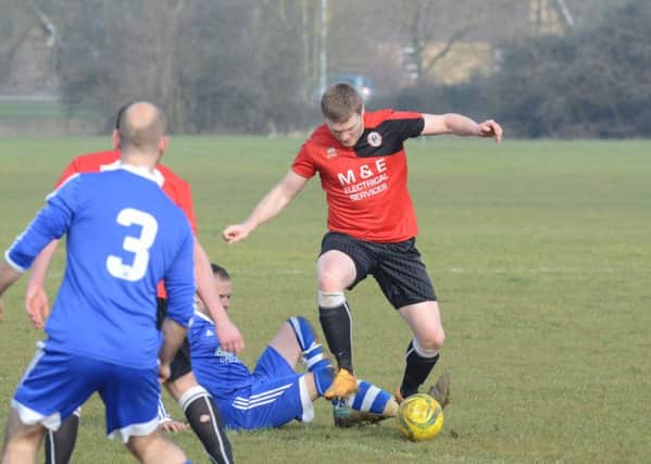 Action from ICA Reserves v Stamford Lions (red). Photo: David Lowndes.