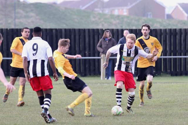 Craig Smith (stripes) on the ball for Peterborough Northern Star in their weekend defeat at Harborough. Photo: Tim Gates.