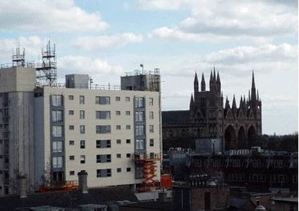 Refurbishment being carried out using a scissor at Hereward Tower in the centre of Peterborough.