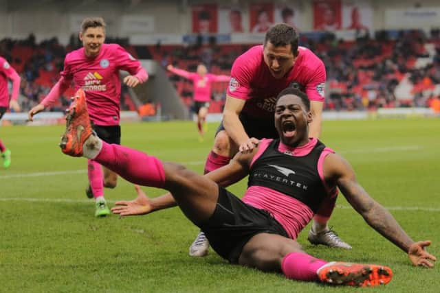 Ricardo Santos slides in front of the Posh fans at Doncaster after his match-winning goal. Photo: Joe Dent/theposh.com.
