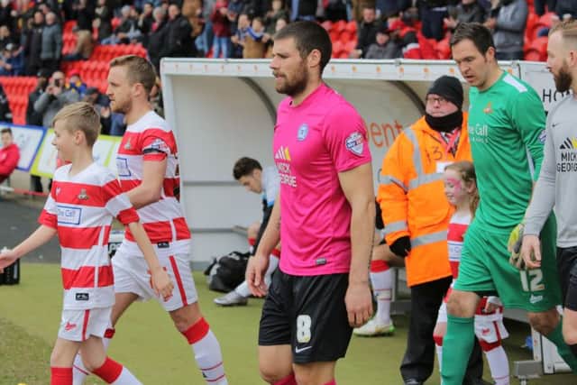 Posh man-of-the-match Michael Bostwick leads the side out at Doncaster. Photo: Joe Dent/theposh.com.