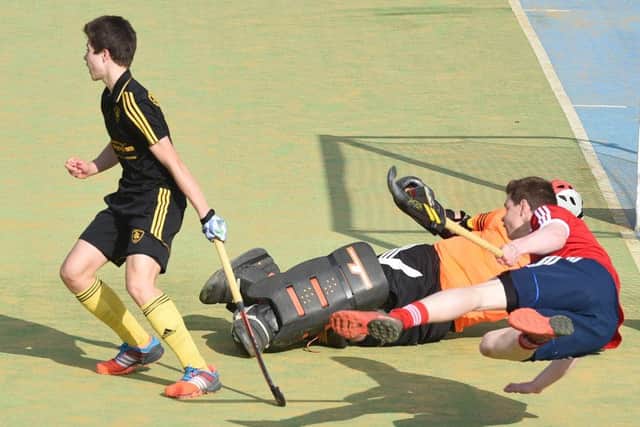 City of Peterborough goalkeeper Cameron Goodey and defender James Fisher (red) cleared the ball during the HA Cup semi-final with Beeston. Photo: David Lowndes.