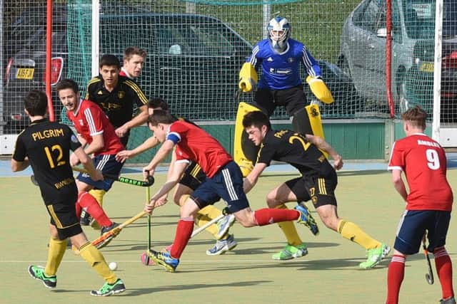 City of Peterborough skipper Ross Booth (red, armband) tries to steer his way through the Beeston defence. Photo: David Lowndes.