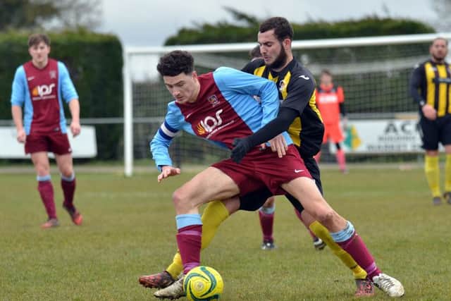 Action from Deeping Rangers Reserves' 2-0 win over Holbeach United Reserves (stripes). Photo: Tim Wilson.