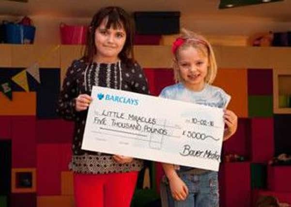 Imogen and Lilly from Little Miracles with the donation from Bauer Media.