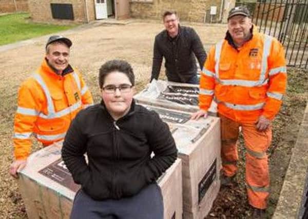 Student Joshua Beattie and business manager Luke Rich receive 6.5 tonnes of bricks from Forterras Kings Dyke staff Pasquale Tucillo and Dave Chevins.
